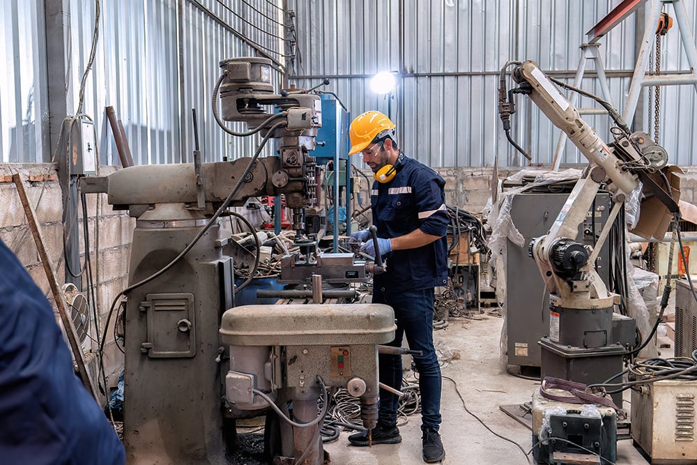 in-robotic-repair-shop-engineer-use-drilling-machi-2024-10-18-07-12-43-utc